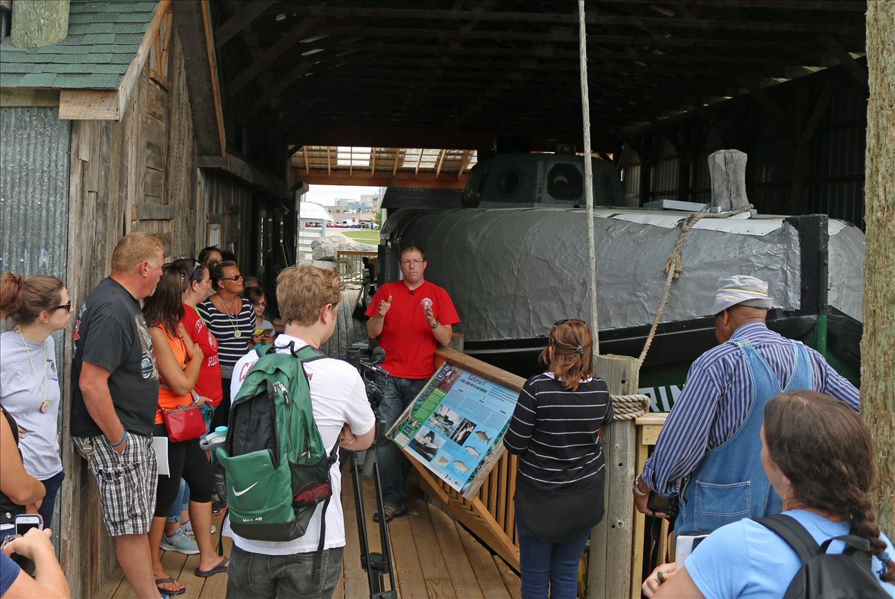 Students visiting the fish tug exbibit at the Jesse Besser Museum.