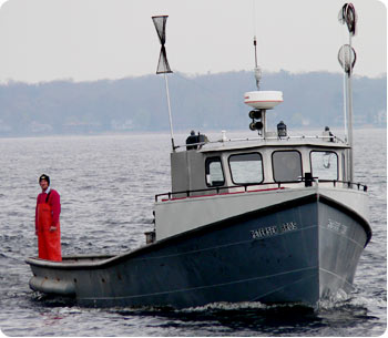 Eric Petersen approaches home port in Muskegon on the Petersen's Fisheries boat